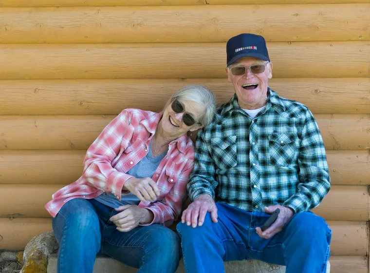 An older couple supporting one another
